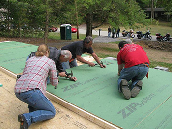 Volunteers building Smoky Mountain Harley House walls.